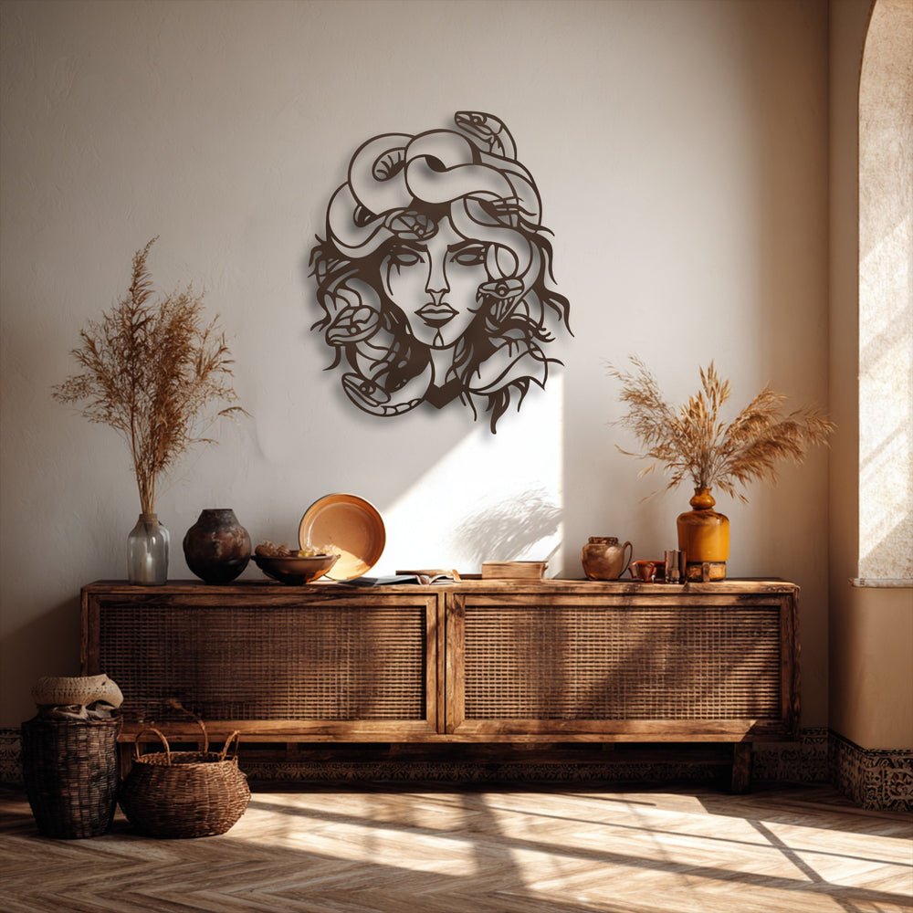 The dark, intricate Medusa mythological snake goddess decorative metal art casts captivating shadows on a textured wall above a rustic console.