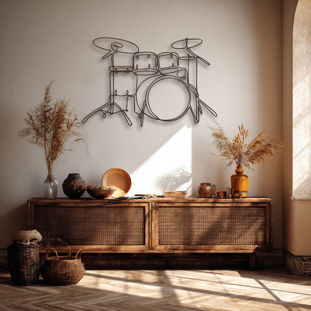 The focal point is a sleek, minimalist drum set line art, serving as a piece of decorative metal art on a light-colored wall.