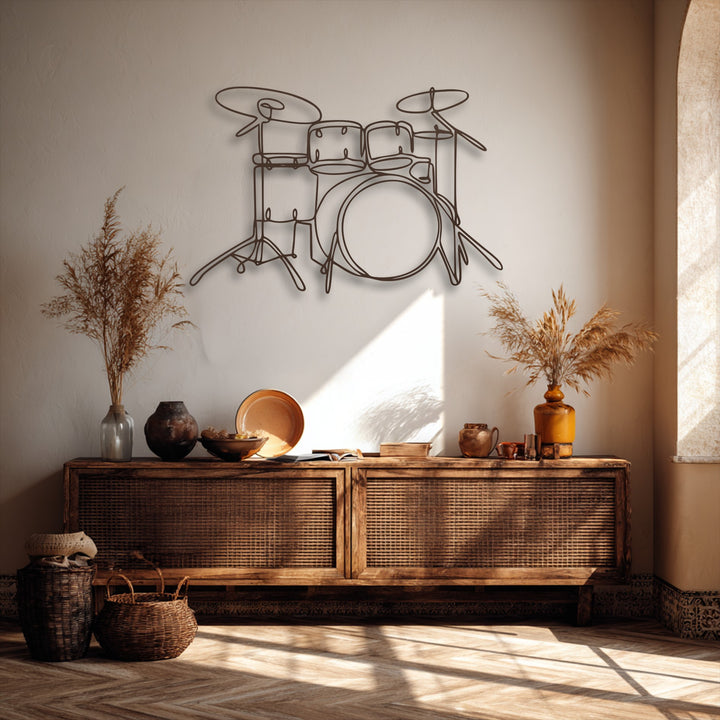 The focal point is a sleek, minimalist drum set line art, serving as a piece of decorative metal art on a light-colored wall.