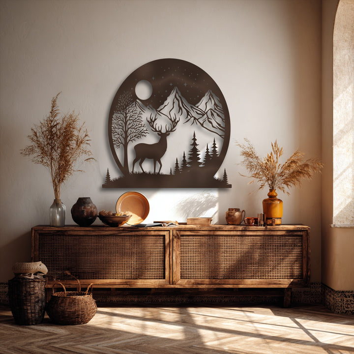 Delicate plumes of dried grass provide a gentle contrast to the Moonlit Wilderness deer & mountain metal wall decor.