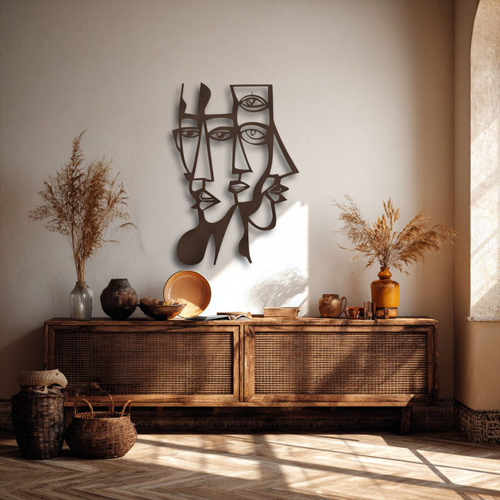 The abstract dual faces of the decorative metal art create compelling depth and visual layers with cast shadows above a rustic console.