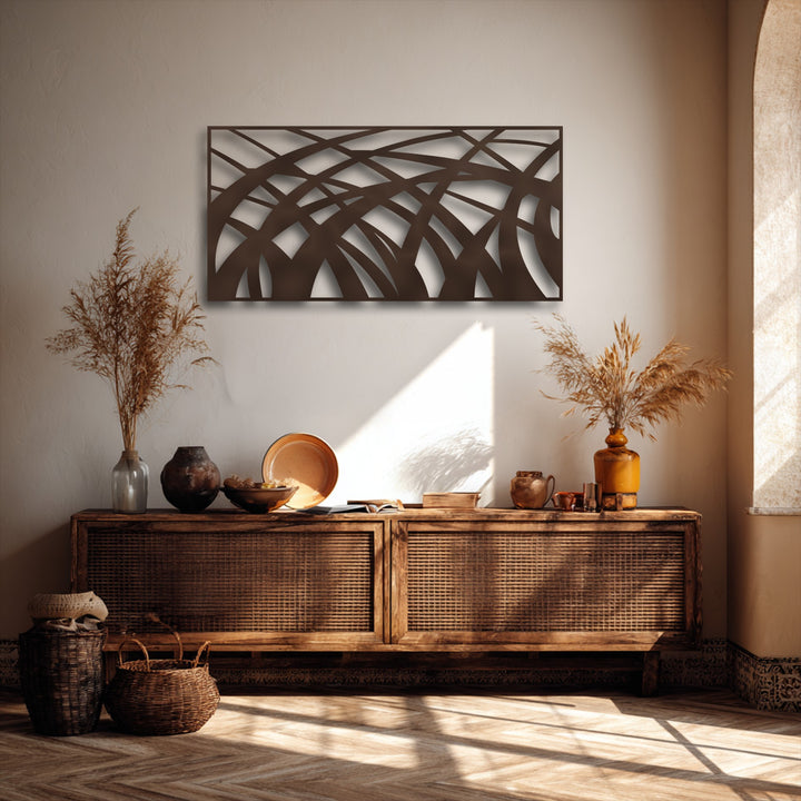 Intricate negative space reveals unique metal wall art with abstract flowing lines forming geometric patterns on a light wall.