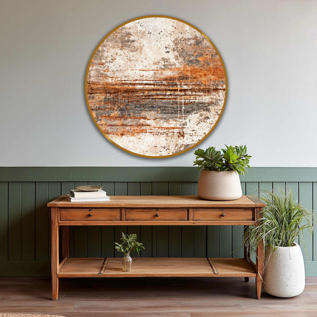 Behind the round earthy abstract oil painting decoration, the backdrop features a paneled lower half in deep green and a soft gray upper wall.