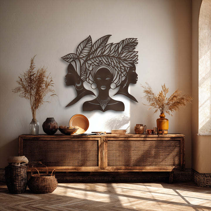 The room's radiant warm color temperature enhances the unique metal wall art featuring African women silhouettes and cultural portrait decor.