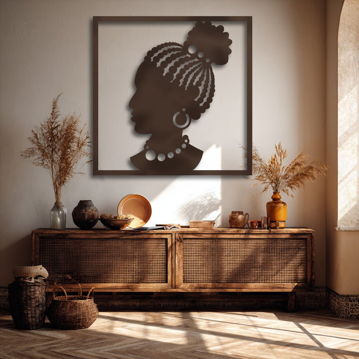 Stillness emanates from the elegant African woman silhouette, a striking metal art for wall, displayed above a console with dried pampas.