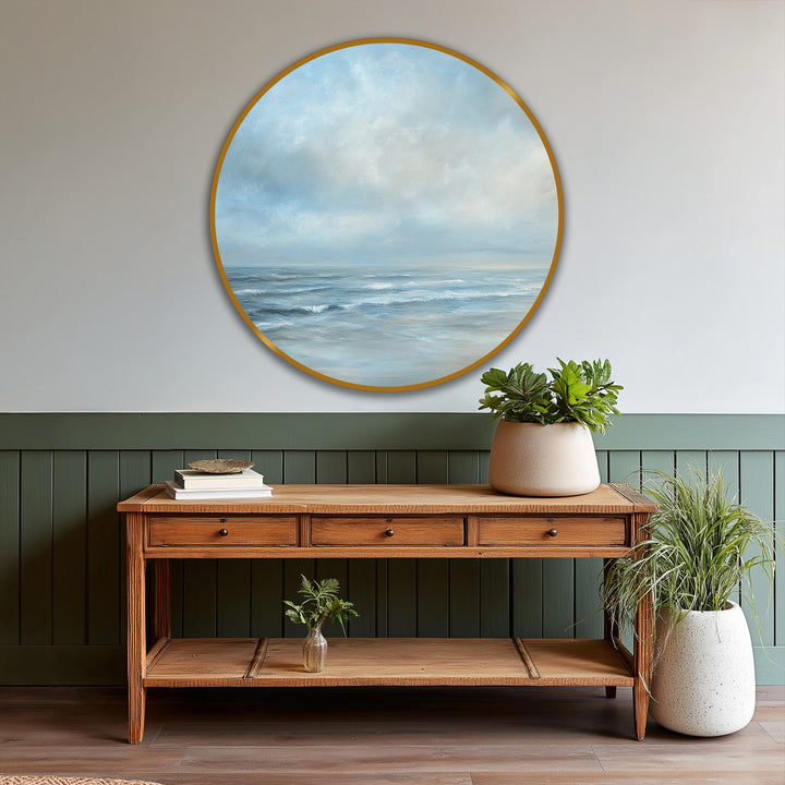 The stillness of the serene seascape in this round oil painting home decor captures quiet ocean waves under a muted sky, a calming coastal view.