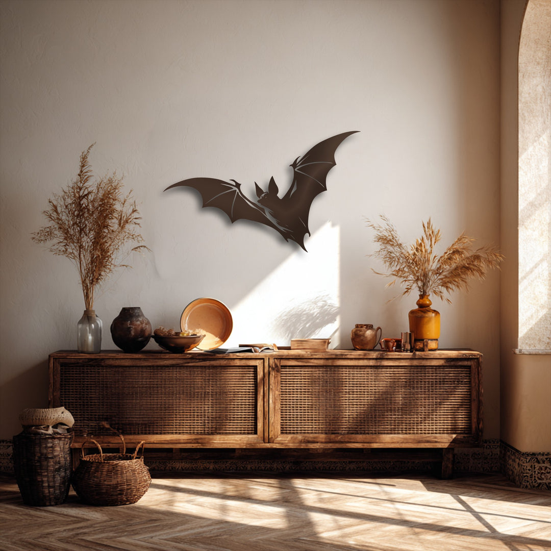 A prominent dark silhouette of a flying bat, featuring textured wings and pointed ears, stands out as a unique piece of decorative metal art.