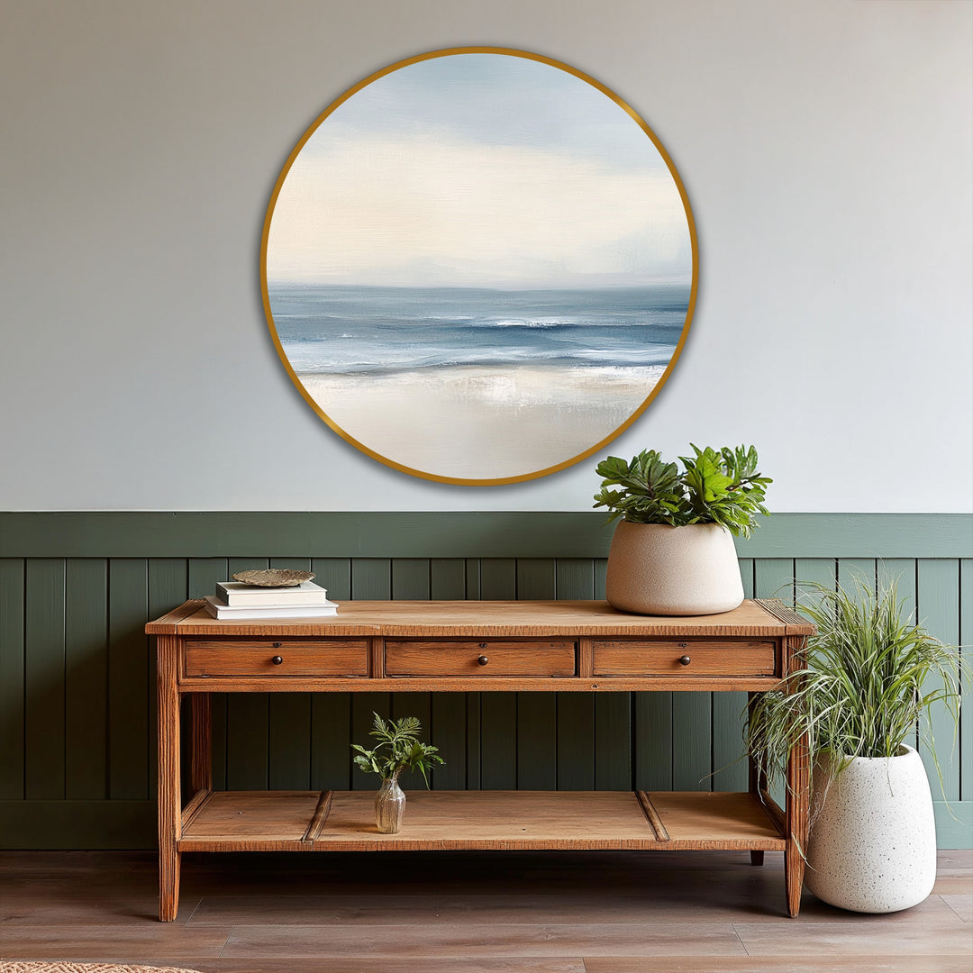 High color contrast defines the soft tide serenity, modern oil painting art depicting the pale sky and deep blue waves meeting the light sand in a circular frame.