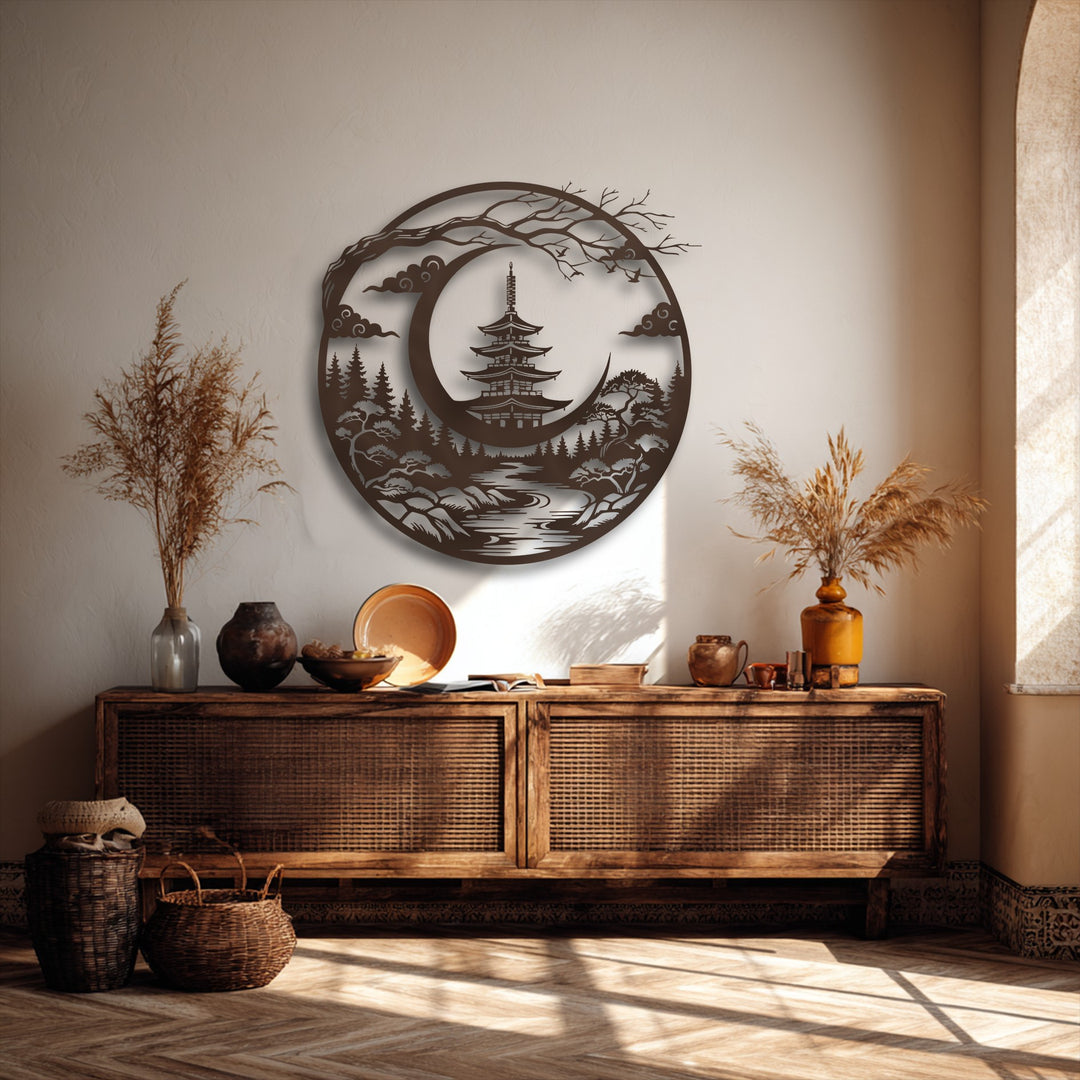 Dramatic play of light and shadow highlights the intricate details of the unique metal wall art depicting a serene Japanese pagoda and crescent moon landscape.
