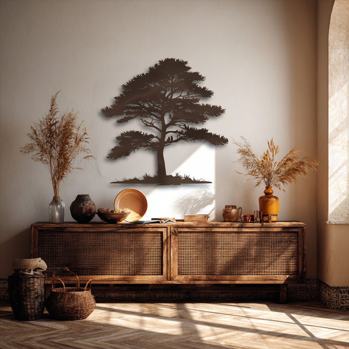 A striking dark brown decorative metal art piece of a pine tree silhouette, with two tiny birds nestled on a branch.