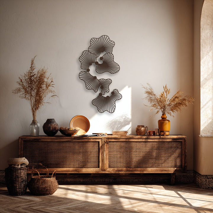 The stillness of the room is enhanced by the elegantly suspended decorative metal art featuring an abstract floral design above a rustic wooden console.