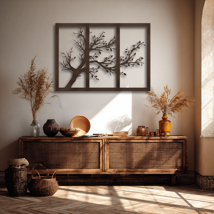 The brightest area highlights the striking minimalist tree silhouette decorative metal art, showcasing its modern nature design against a sunlit wall.