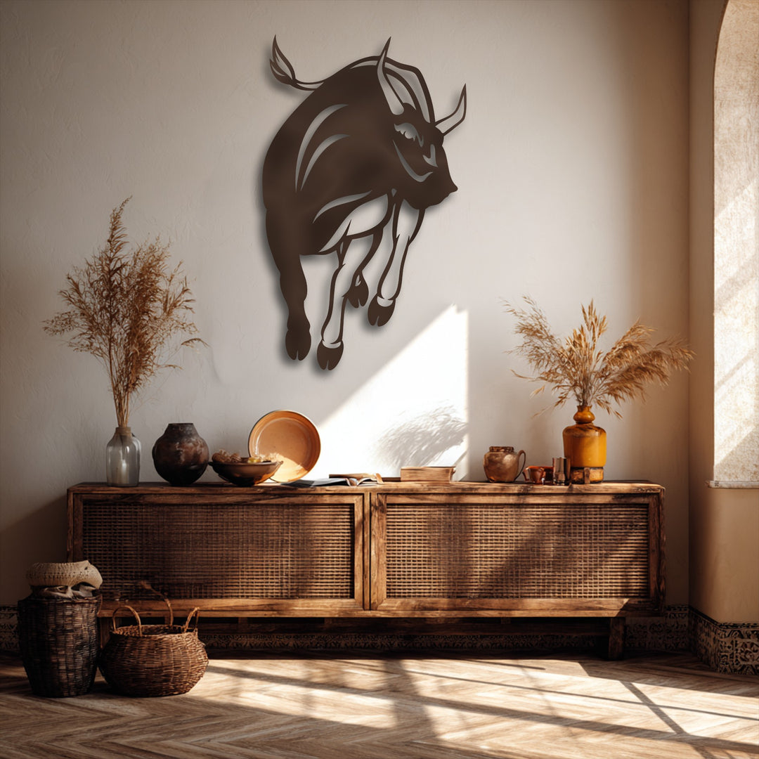 Subtle plaster wall texture enhances the smooth charging bull silhouette metal artwork, alongside a textured cane console and woven baskets.