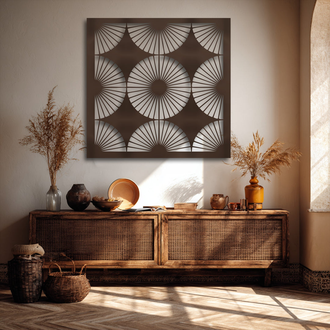 Delicate dried grasses softly complement the dark brown radiant fan pattern metal artwork, creating a tranquil bohemian ambiance.