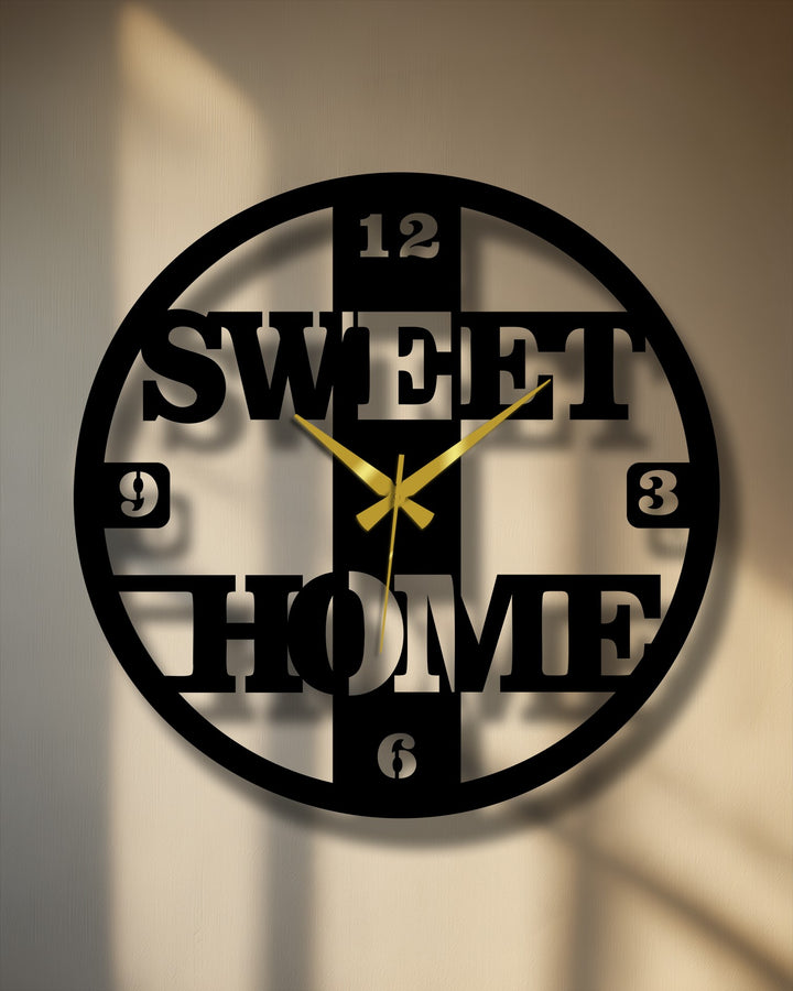 High color contrast defines this sweet home metal wall clock featuring a modern, decorative design and contrasting gold hands as eye-catching metal artwork.