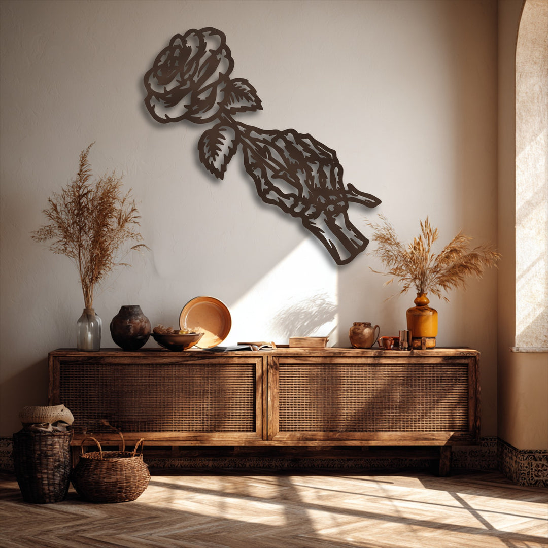 A striking transition from bright sun to deep shade on the wall and floor showcases the dark, detailed gothic rose skeleton metal artwork.