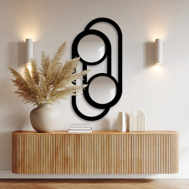 Vertical double circle link shaped metal art for wall mirror serves as a stylish focal point in this decorating with wall mirrors arrangement.