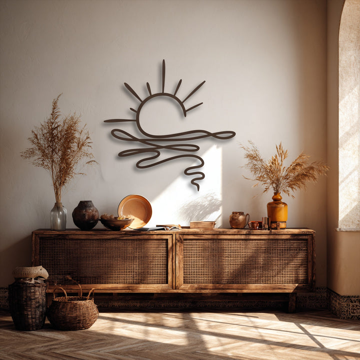 The focal point showcases an elegant abstract sunrise decorative metal art piece with graceful lines depicting a sunburst over undulating waves.