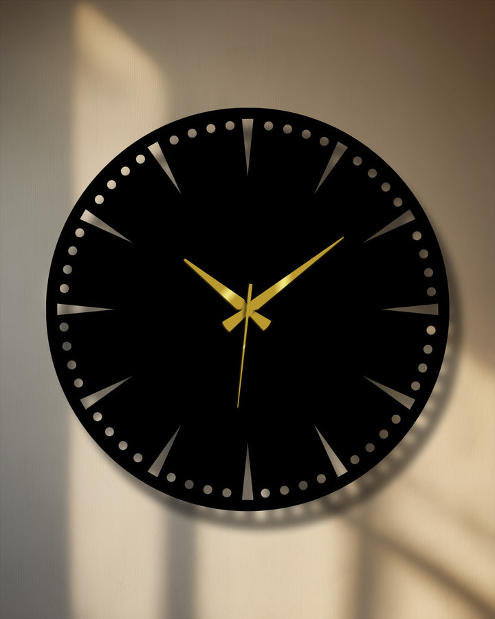 High color contrast defines this luxury black metal wall clock, a unique metal wall art piece, featuring minimalist gold hands against a shadowed wall.