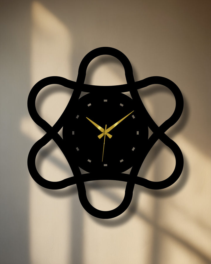Subtle surface texture highlights the elegant, decoration wall art aesthetic of the minimal loop geometry metal wall clock's matte black finish and looping design.
