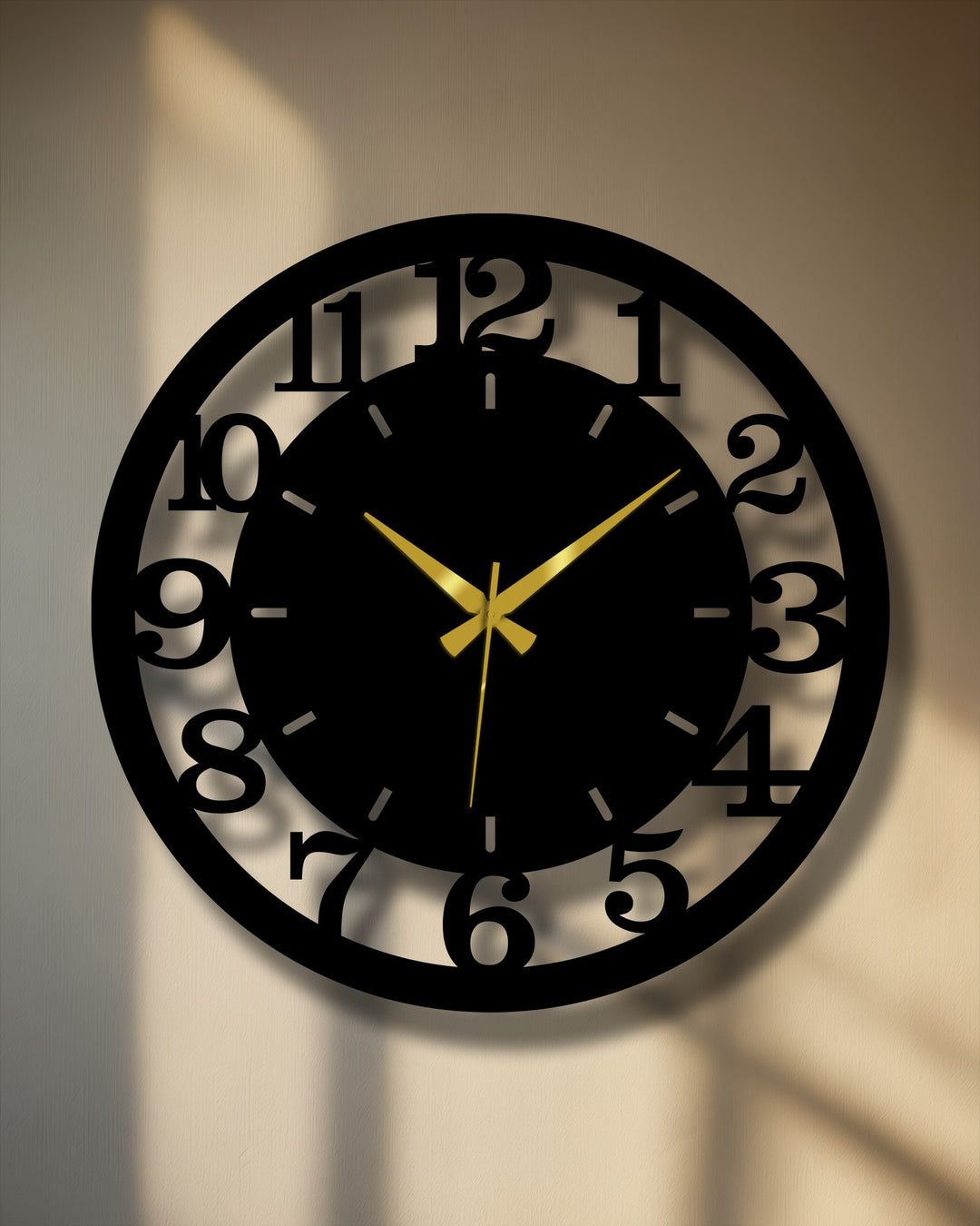 Layered depth is created in this black numbered metal wall clock, with gold hands accentuating its circular metal wall decor design.