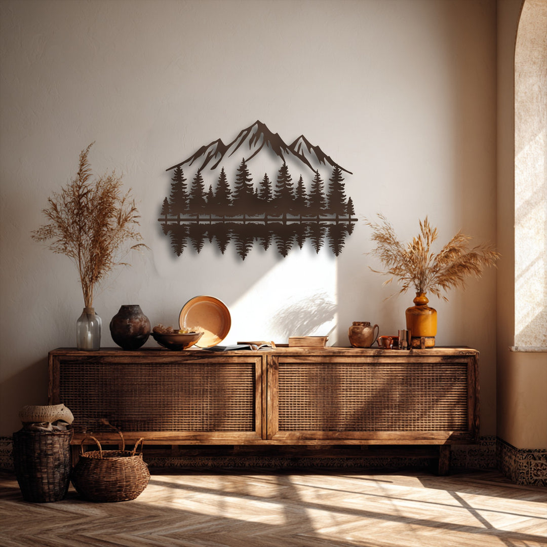 The intricate decorative metal art of mountains and a forest with a serene reflection casts shadows, adding layers of depth to the rustic interior.