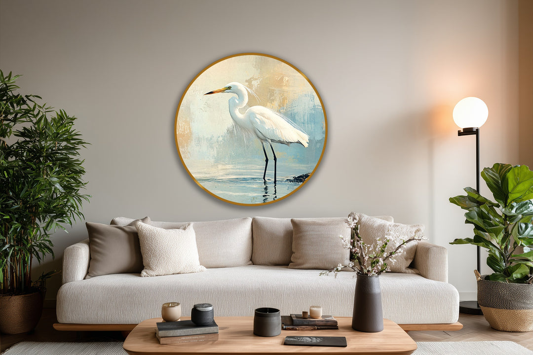 The focal point is the fine art round oil painting home decor portraying a white egret standing gracefully in calm waters against a muted coastal backdrop.