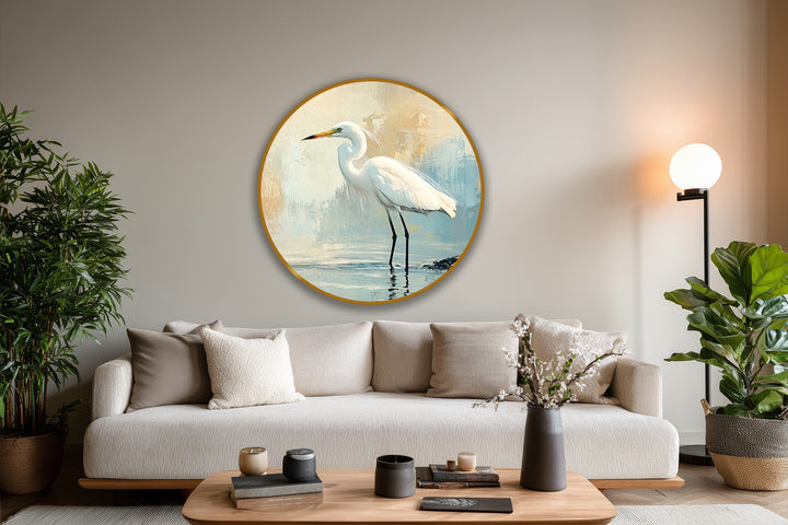 The focal point is the fine art round oil painting home decor portraying a white egret standing gracefully in calm waters against a muted coastal backdrop.