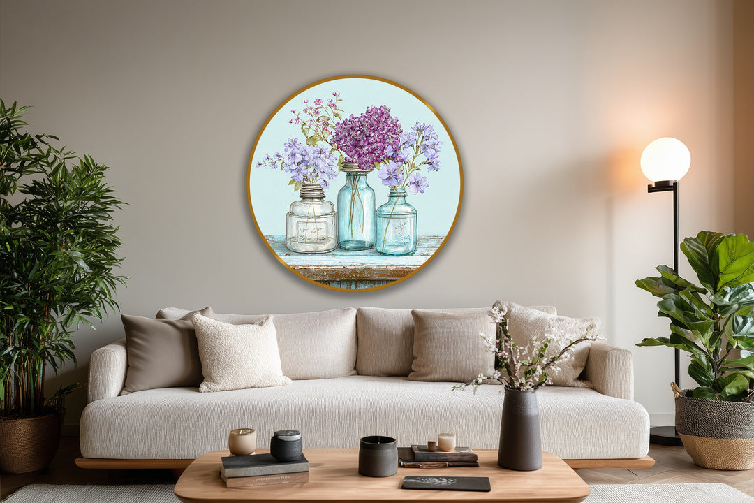 Circular oil painting home decor features a golden-edged frame enclosing three vintage jars with wildflowers, emphasizing round and rectangular geometric elements.