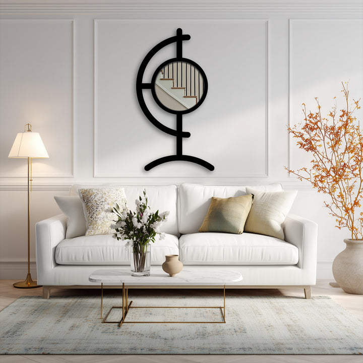 Highlighting the realistic detail, this image displays a sculptural black metal Orbit Line floor mirror for wall decor, showcasing its round center mirror framed by a unique metal design.