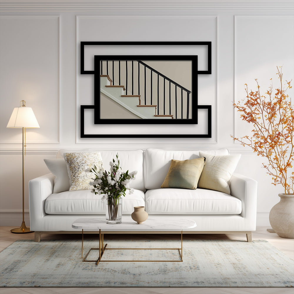 Soft light accentuates the double frame geometry of the modern black rectangular framed wall mirror, adding a gentle contrast to the metal art for wall piece.