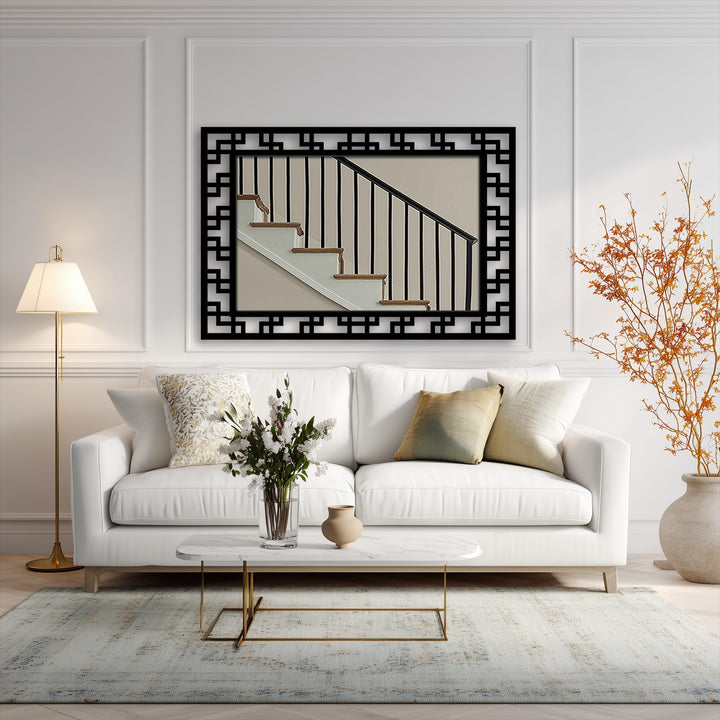 Geometric maze pattern in black forms a framed wall mirror featuring a stairwell.