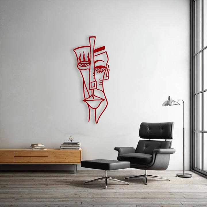 White walls provide a clean backdrop for the striking red abstract tribal face metal artwork, a captivating modern mask metal artwork.