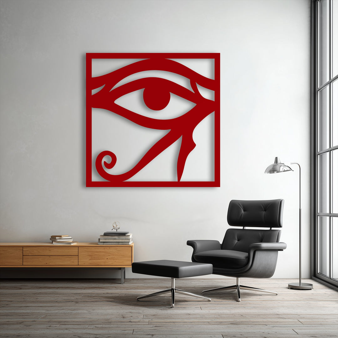 The striking interplay of light and shadow dramatically defines the contours of the bold red Eye of Horus decorative metal art, adding depth.
