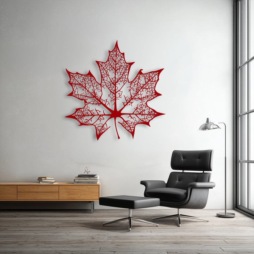 The vibrant red of the intricate maple leaf decorative metal art stands out against the white wall in this modern interior.