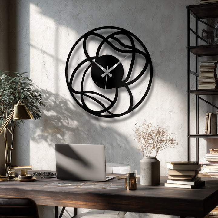 Organic forms intertwine in this metal artwork of a modern, abstract wall clock, creating a geometric decorative piece with interwoven lines and a captivating circular design.