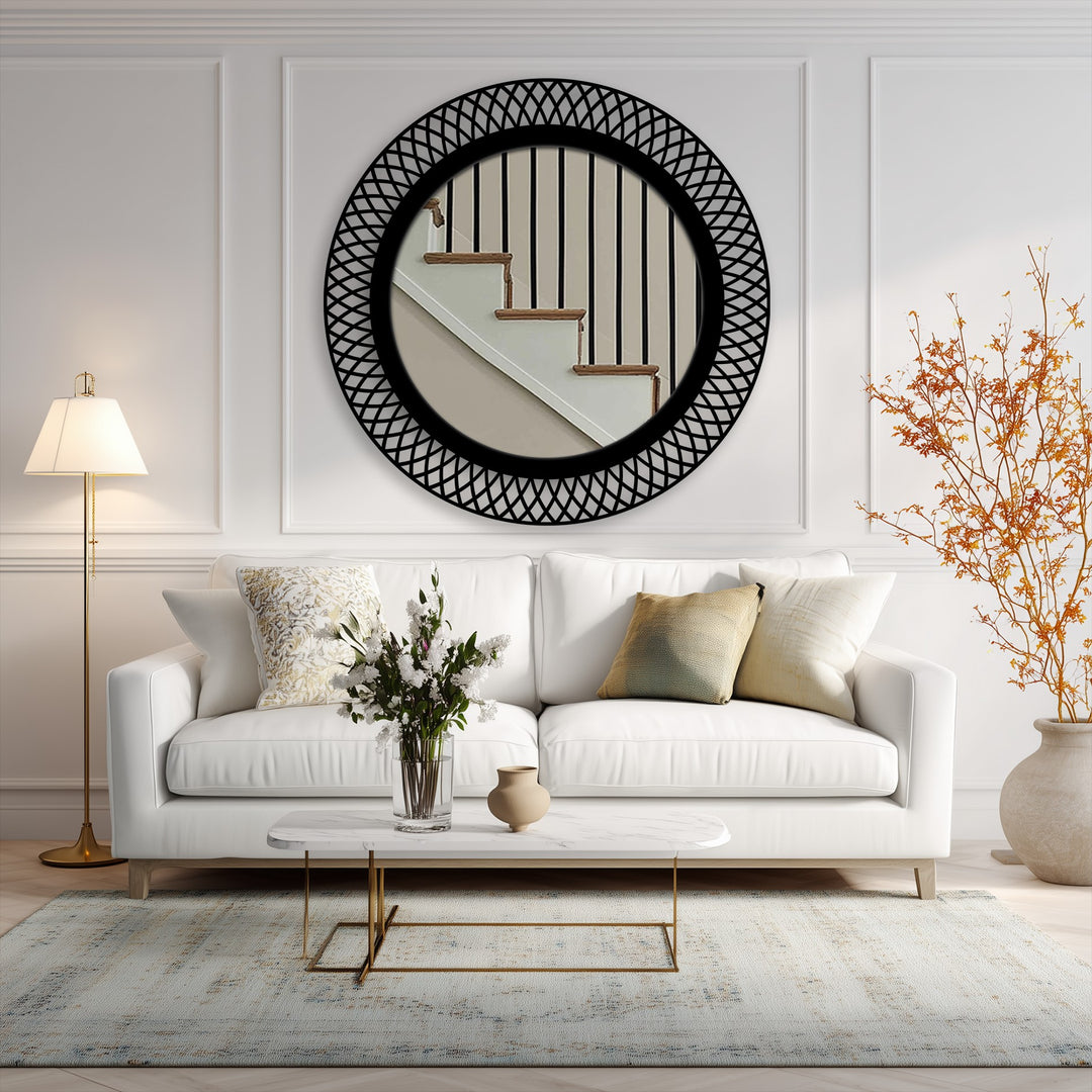 The muted color saturation of this image highlights a striking black geometric lattice modern wall mirror reflecting a staircase.