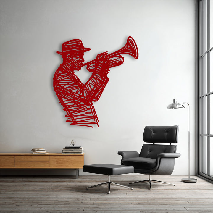 The matte red finish of the jazz trumpet player metal wall decor features a bold abstract silhouette on a white wall.
