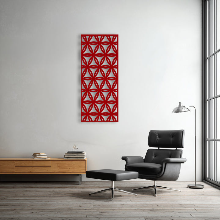 The plush black leather armchair and ottoman offer a comfortable spot to view the striking red geometric metal wall decor.