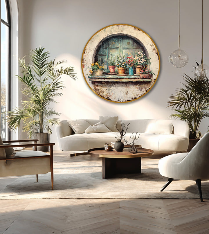 White negative space accentuates a round oil painting home decor depiction of a rustic window with flower pots above a bright, modern living room.