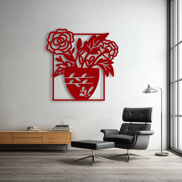 The delicate, flowing curves of the flower petals and leaves within the red floral vase silhouette define the softest element of this unique metal wall art.