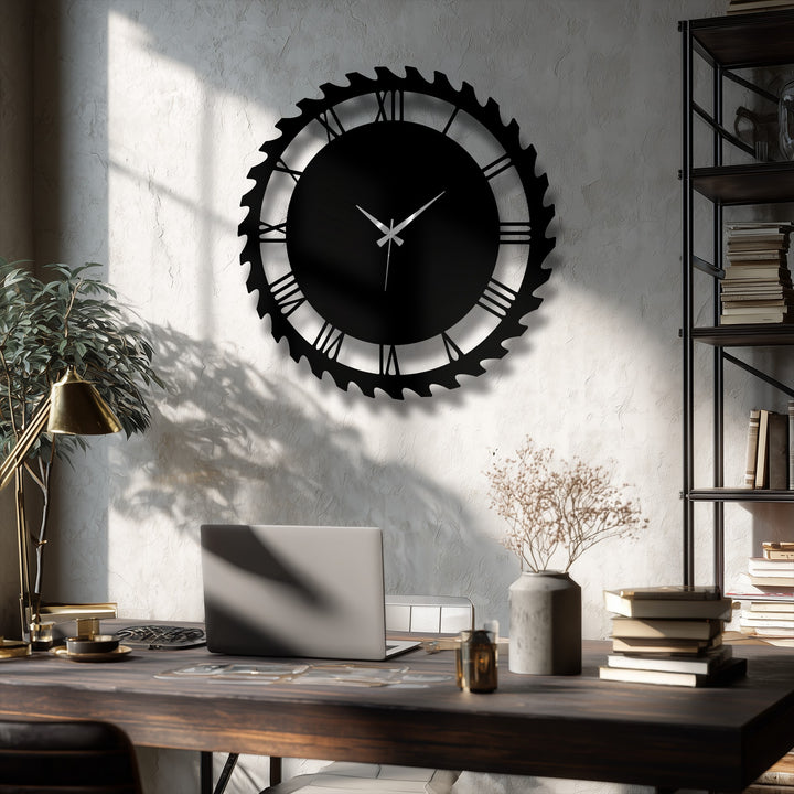 Foreground details include a laptop, a cup, and a vase with dried flowers on a dark wooden desk, complementing the industrial gear style metal wall decor.
