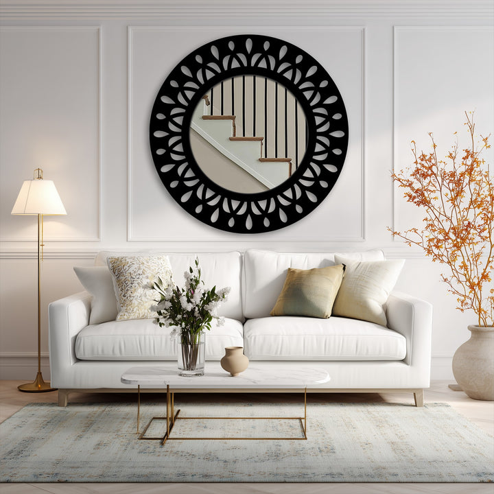 The bright lamp illuminates a sophisticated living room, featuring a striking black leaf motif round metal art for wall reflecting stairs.