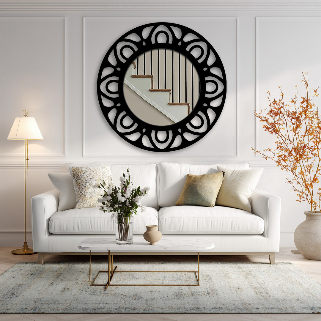 Surface textures exhibit the sleek, reflective glass and the intricate, matte black finish of this modern pattern ring framed wall mirror.