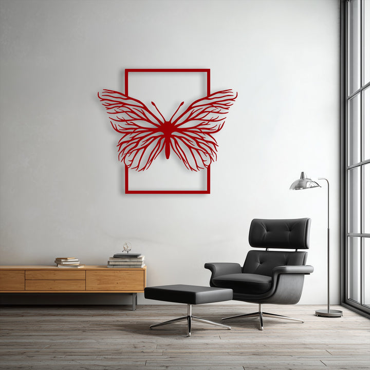 The delicate, organic wing structure of the unique metal wall art, an elegant red butterfly in a frame, casts soft shadows on the minimalist wall.