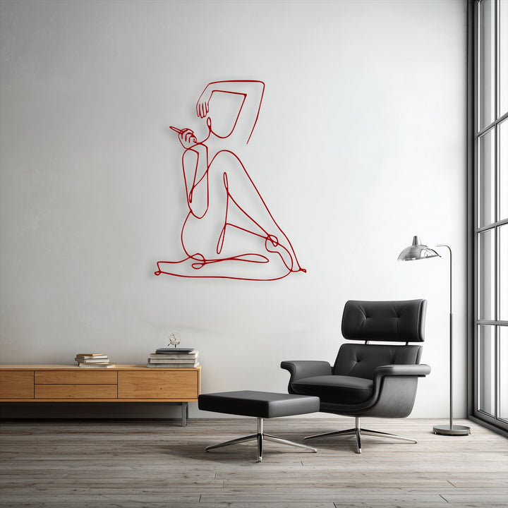 The background features a light, textured wall showcasing an elegant abstract figure minimalist female line art metal wall decor.