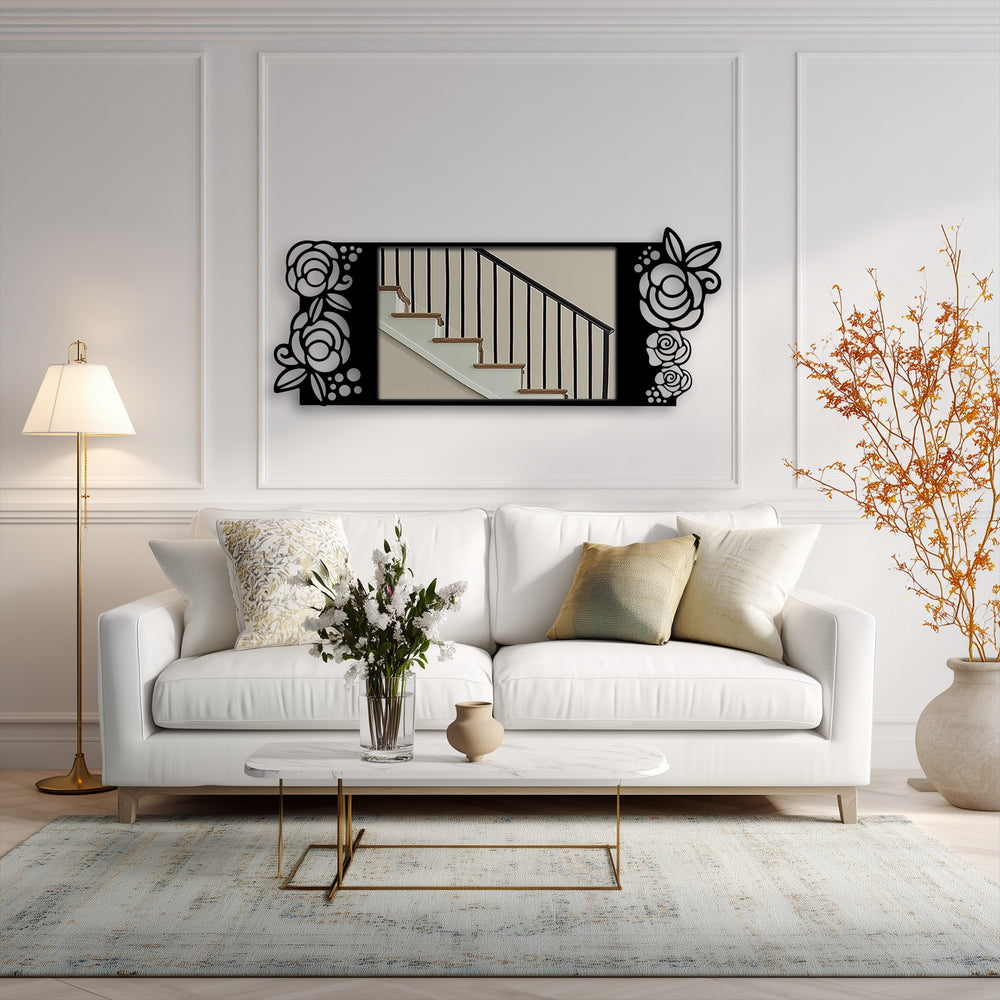 Focusing on the mirror's black metal rose motif, a decoration wall art piece reflecting a staircase adorns a stylish living room.