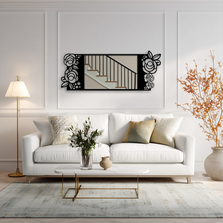 Focusing on the mirror's black metal rose motif, a decoration wall art piece reflecting a staircase adorns a stylish living room.