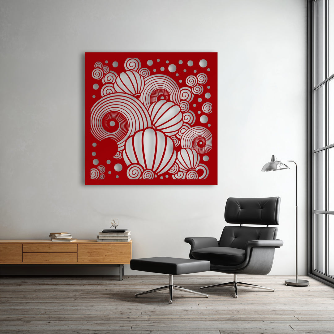 Plush black leather seating offers comfort next to decorative metal art featuring red abstract spirals and balloon patterns.