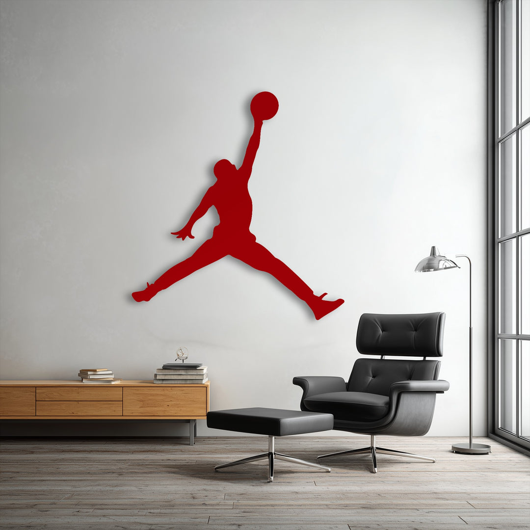 Soft, tufted black leather upholstery of the lounge chair offers comfort beneath a bold basketball jump player metal art for wall.